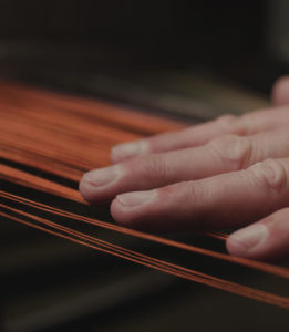 Weaver's hand on cashmere fibres
